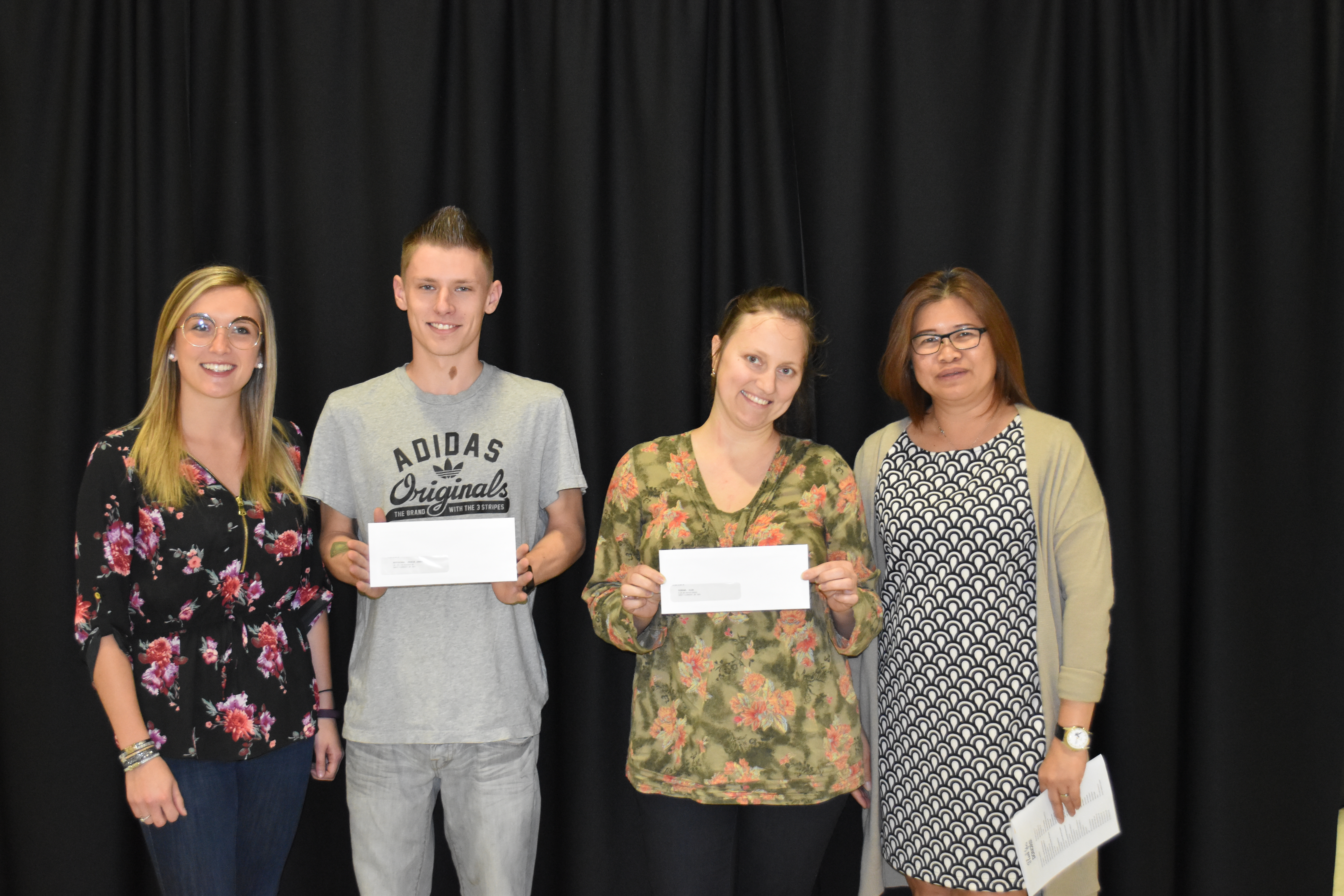 Newcomer Welcome Centre donor with student scholarship recipients