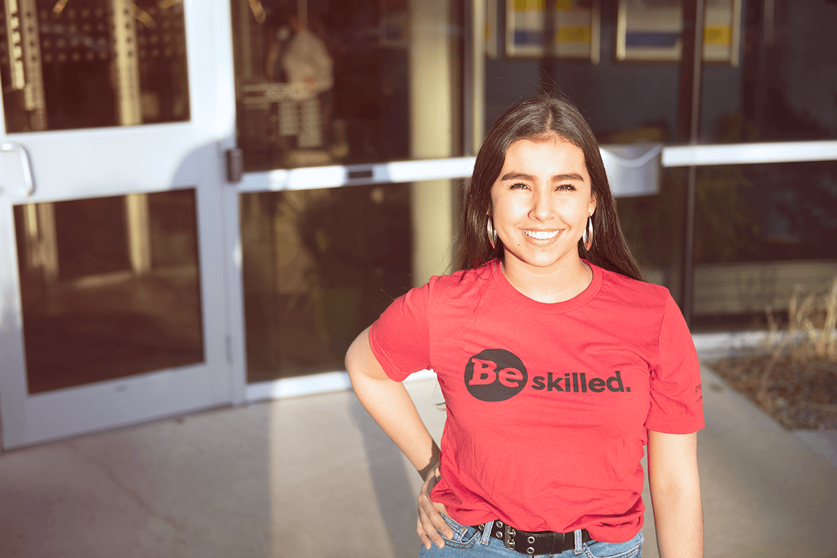 Student wearing a red "Be Skilled" t-shirt