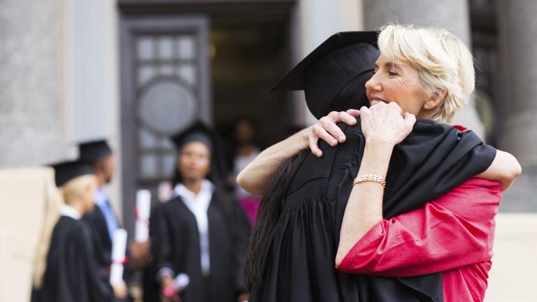 Parent hugging their child at graduation