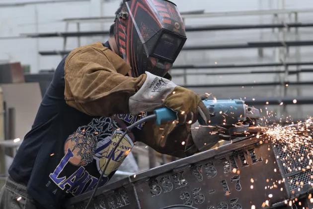 welder grinding metal
